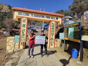 trekkers at Ghorepani poonhill entrance gate with banner of info nepal