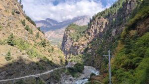 Lush green landscapes and flowing river on the trail of Dharapani 