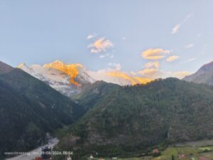 A golden light reflected by surrounding peaks during the sunrise on the trek to Annapurna circuit trek.
