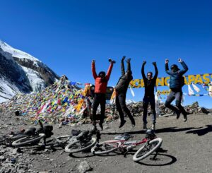 People jumping at Thorong La pass