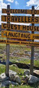 A rustic wooden sign with as a landmark during langtang trek