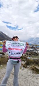 A trekker holding banner for Info Nepal travel & Treks