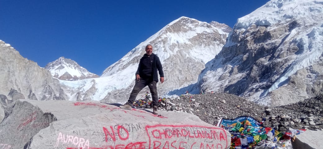 Trekker standing on top of rock at Everest Base camp