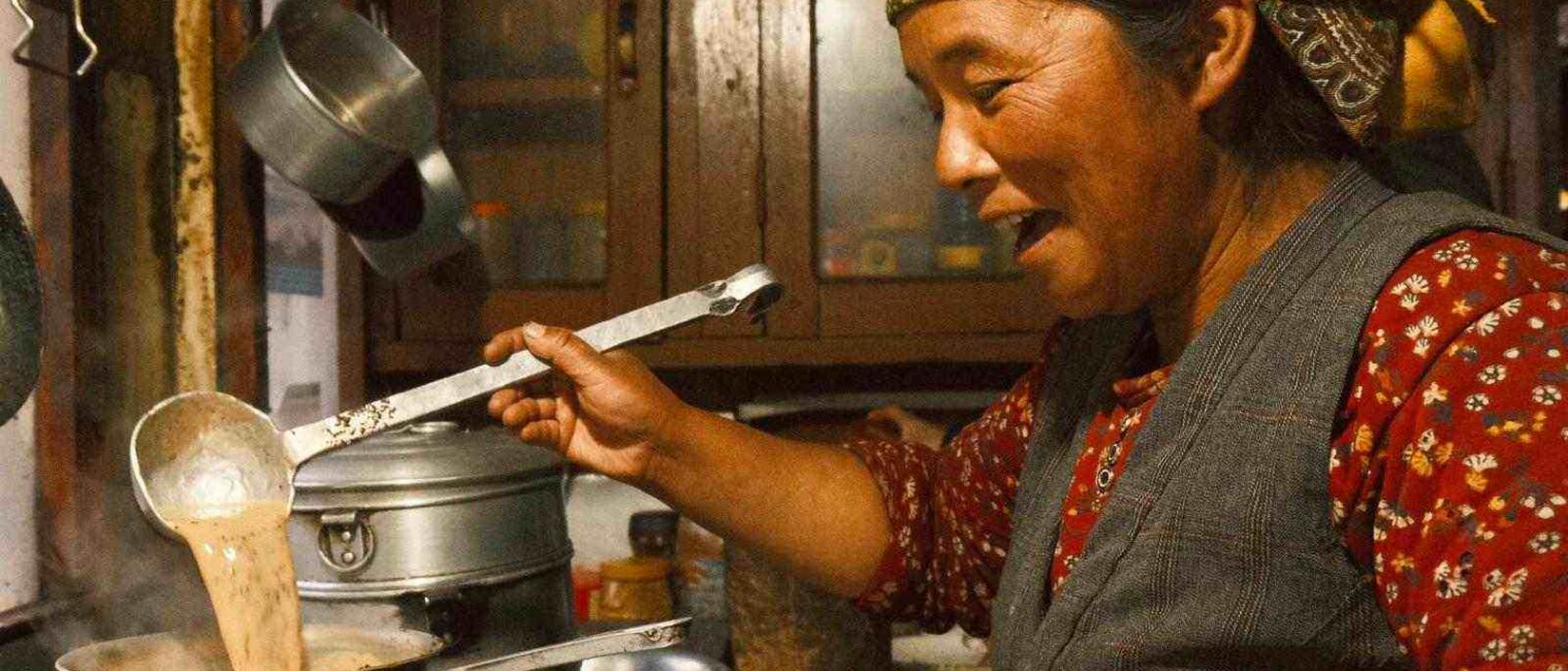 local woman making tea during Tamang Heritage Gosaikunda Trek