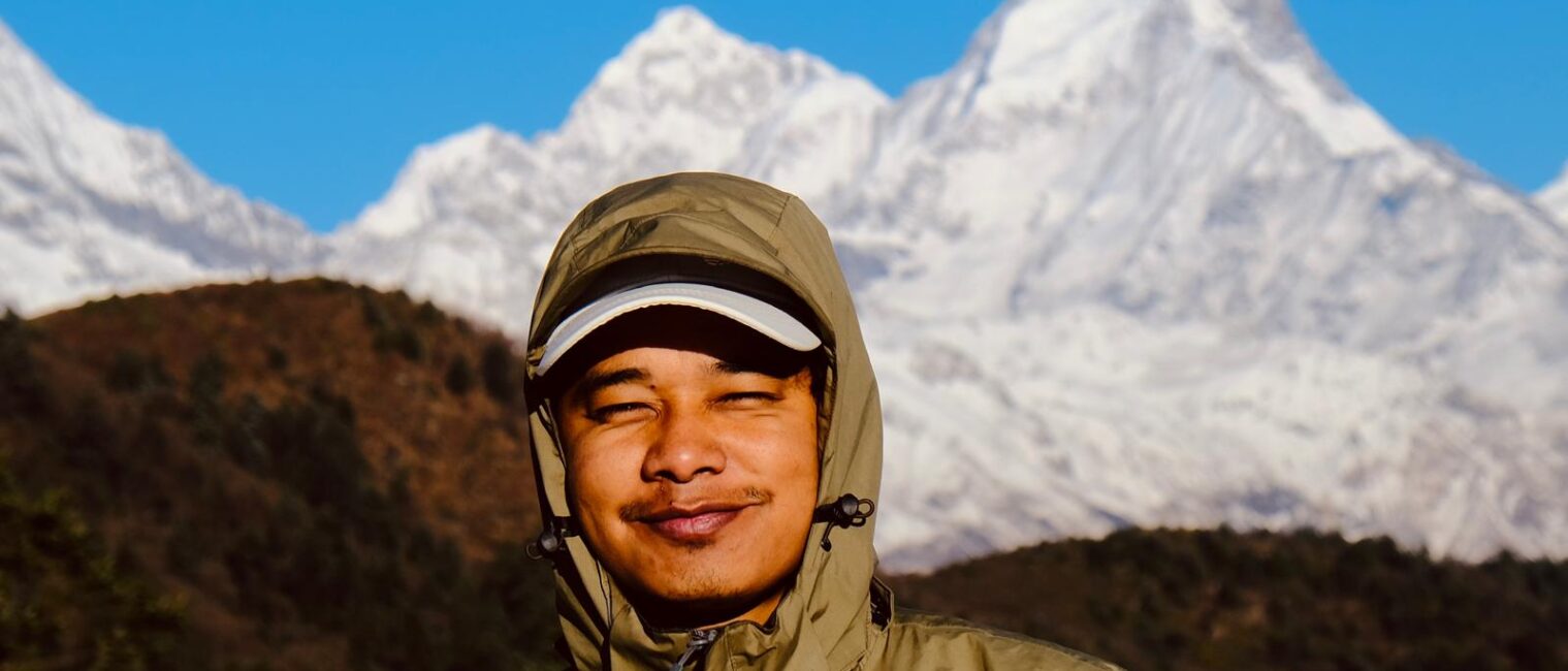 Man standing with snowy mountain background Tamang Heritage Gosaikunda Trek